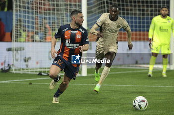 2024-03-17 - Jordan Ferri of Montpellier, Randal Kolo Muani of PSG during the French championship Ligue 1 football match between Montpellier HSC (MHSC) and Paris Saint-Germain (PSG) on March 17, 2024 at La Mosson stadium in Montpellier, France - FOOTBALL - FRENCH CHAMP - MONTPELLIER V PARIS SG - FRENCH LIGUE 1 - SOCCER