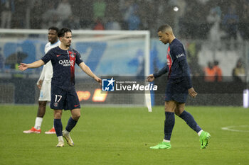 2024-03-31 - Kylian Mbappe of PSG - here saluted by Vitinha of PSG (left) - leaves the pitch when being replaced during the French championship Ligue 1 football match between Olympique de Marseille (OM) and Paris Saint-Germain (PSG) on March 31, 2024 at Stade Velodrome in Marseille, France - FOOTBALL - FRENCH CHAMP - MARSEILLE V PARIS SG - FRENCH LIGUE 1 - SOCCER