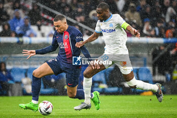 2024-03-31 - Kylian MBAPPE of PSG and Geoffrey KONDOGBIA of Marseille during the French championship Ligue 1 football match between Olympique de Marseille and Paris Saint-Germain on March 31, 2024 at Orange Velodrome stadium in Marseille, France - FOOTBALL - FRENCH CHAMP - MARSEILLE V PARIS SG - FRENCH LIGUE 1 - SOCCER