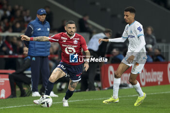 2024-04-05 - Remy Cabella of Lille, Azzedine Ounahi of Marseille during the French championship Ligue 1 football match between Lille OSC (LOSC) and Olympique de Marseille (OM) on April 5, 2024 at Stade Pierre Mauroy in Villeneuve-d'Ascq near Lille, France - FOOTBALL - FRENCH CHAMP - LILLE V MARSEILLE - FRENCH LIGUE 1 - SOCCER