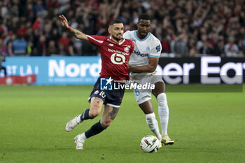 2024-04-05 - Remy Cabella of Lille, Ulisses Garcia of Marseille during the French championship Ligue 1 football match between Lille OSC (LOSC) and Olympique de Marseille (OM) on April 5, 2024 at Stade Pierre Mauroy in Villeneuve-d'Ascq near Lille, France - FOOTBALL - FRENCH CHAMP - LILLE V MARSEILLE - FRENCH LIGUE 1 - SOCCER