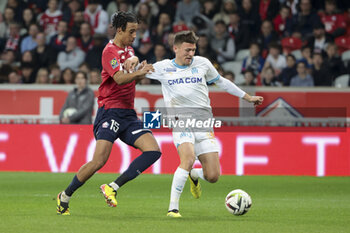 2024-04-05 - Quentin Merlin of Marseille, left Leny Yoro of Lille during the French championship Ligue 1 football match between Lille OSC (LOSC) and Olympique de Marseille (OM) on April 5, 2024 at Stade Pierre Mauroy in Villeneuve-d'Ascq near Lille, France - FOOTBALL - FRENCH CHAMP - LILLE V MARSEILLE - FRENCH LIGUE 1 - SOCCER