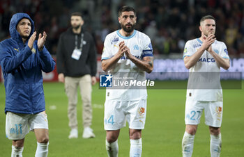 2024-04-05 - Amine Harit, Samuel Gigot, Jordan Veretout of Marseille salute the supporters following the French championship Ligue 1 football match between Lille OSC (LOSC) and Olympique de Marseille (OM) on April 5, 2024 at Stade Pierre Mauroy in Villeneuve-d'Ascq near Lille, France - FOOTBALL - FRENCH CHAMP - LILLE V MARSEILLE - FRENCH LIGUE 1 - SOCCER