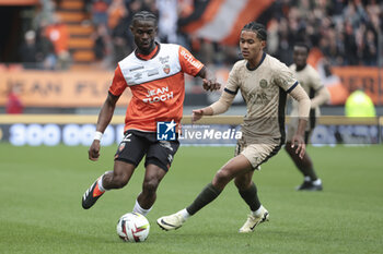 2024-04-24 - Darlin Yongwa of Lorient, Senny Mayulu of PSG during the French championship Ligue 1 football match between FC Lorient and Paris Saint-Germain (PSG) on April 24, 2024 at Stade du Moustoir in Lorient, France - FOOTBALL - FRENCH CHAMP - LORIENT V PARIS SG - FRENCH LIGUE 1 - SOCCER