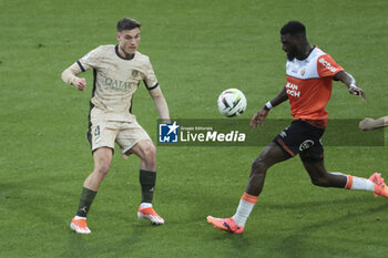 2024-04-24 - Manuel Ugarte of PSG, Tiemoue Bakayoko of Lorient during the French championship Ligue 1 football match between FC Lorient and Paris Saint-Germain (PSG) on April 24, 2024 at Stade du Moustoir in Lorient, France - FOOTBALL - FRENCH CHAMP - LORIENT V PARIS SG - FRENCH LIGUE 1 - SOCCER