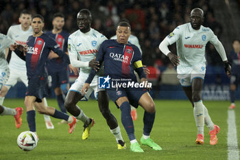 2024-04-27 - Kylian Mbappe of PSG between Arouna Sangante and Abdoulaye Toure of Le Havre during the French championship Ligue 1 football match between Paris Saint-Germain (PSG) and Le Havre AC (HAC) on April 27, 2024 at Parc des Princes stadium in Paris, France - FOOTBALL - FRENCH CHAMP - PARIS SG V LE HAVRE - FRENCH LIGUE 1 - SOCCER