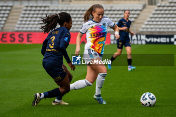 2024-10-12 - Mia Gyau of Stade de Reims and Julie Dufour of Paris FC fight for the ball during the French championship, Arkema Premier Ligue football match between Paris FC and Stade de Reims on 12 October 2024 at Sebastien Charlety stadium in Paris, France - FOOTBALL - WOMEN'S FRENCH CHAMP - PARIS FC V REIMS - FRENCH WOMEN DIVISION 1 - SOCCER