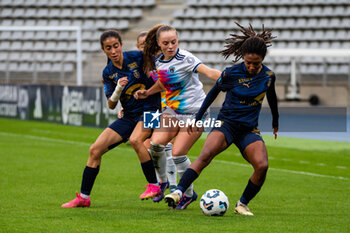 2024-10-12 - Jade Nassi of Stade de Reims, Lou Bogaert of Paris FC and Mia Gyau of Stade de Reims fight for the ball during the French championship, Arkema Premier Ligue football match between Paris FC and Stade de Reims on 12 October 2024 at Sebastien Charlety stadium in Paris, France - FOOTBALL - WOMEN'S FRENCH CHAMP - PARIS FC V REIMS - FRENCH WOMEN DIVISION 1 - SOCCER