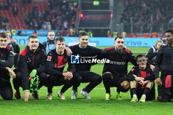 2024-02-10 - Coach Xabi Alonso with players of Bayer 04 Leverkusen celebrate at full time during the German championship Bundesliga football match between Bayer 04 Leverkusen and Bayern Munich on February 10, 2024 at BayArena in Leverkusen, Germany - FOOTBALL - GERMAN CHAMP - BAYER LEVERKUSEN V BAYERN MUNICH - GERMAN BUNDESLIGA - SOCCER