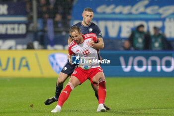 2024-02-18 - Harry Kane of Bayern Munich and Ivan Ordets of Bochum during the German championship Bundesliga football match between VfL Bochum and Bayern Munich on February 18, 2024 at Vonovia Ruhrstadion in Bochum, Germany - FOOTBALL - GERMAN CHAMP - BOCHUM V BAYERN MUNICH - GERMAN BUNDESLIGA - SOCCER