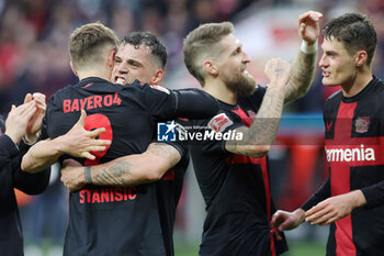 2024-03-30 - Granit Xhaka, Josip Stanisic of Bayer Leverkusen celebrate during the German championship Bundesliga football match between Bayer 04 Leverkusen and TSG Hoffenheim on March 30, 2024 at BayArena in Leverkusen, Germany - FOOTBALL - GERMAN CHAMP - LEVERKUSEN V HOFFENHEIM - GERMAN BUNDESLIGA - SOCCER