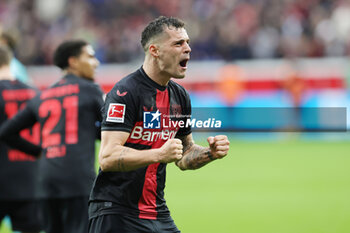 2024-03-30 - Granit Xhaka of Bayer Leverkusen celebrates after the 2-1 goal during the German championship Bundesliga football match between Bayer 04 Leverkusen and TSG Hoffenheim on March 30, 2024 at BayArena in Leverkusen, Germany - FOOTBALL - GERMAN CHAMP - LEVERKUSEN V HOFFENHEIM - GERMAN BUNDESLIGA - SOCCER