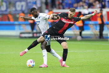 2024-03-30 - Robert Andrich of Leverkusen and Ihlas Bebou of Hoffenheim during the German championship Bundesliga football match between Bayer 04 Leverkusen and TSG Hoffenheim on March 30, 2024 at BayArena in Leverkusen, Germany - FOOTBALL - GERMAN CHAMP - LEVERKUSEN V HOFFENHEIM - GERMAN BUNDESLIGA - SOCCER