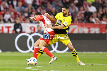 2024-03-30 - Jamal Musiala of Bayern Munich and Emre Can of Borussia Dortmund during the German championship Bundesliga football match between Bayern Munich and Borussia Dortmund on March 30, 2024 at Allianz Arena in Munich, Germany - FOOTBALL - GERMAN CHAMP - BAYERN MUNICH V DORTMUND - GERMAN BUNDESLIGA - SOCCER