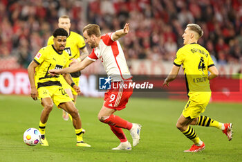 2024-03-30 - Harry Kane of Bayern Munich and Ian Maatsen, Nico Schlotterbeck of Borussia Dortmund during the German championship Bundesliga football match between Bayern Munich and Borussia Dortmund on March 30, 2024 at Allianz Arena in Munich, Germany - FOOTBALL - GERMAN CHAMP - BAYERN MUNICH V DORTMUND - GERMAN BUNDESLIGA - SOCCER