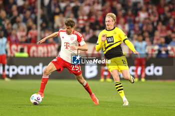 2024-03-30 - Thomas Müller of Bayern Munich and Julian Brandt of Borussia Dortmund during the German championship Bundesliga football match between Bayern Munich and Borussia Dortmund on March 30, 2024 at Allianz Arena in Munich, Germany - FOOTBALL - GERMAN CHAMP - BAYERN MUNICH V DORTMUND - GERMAN BUNDESLIGA - SOCCER