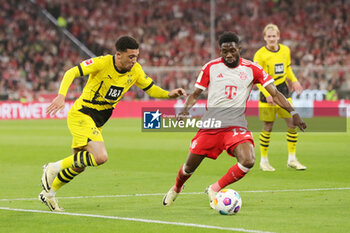 2024-03-30 - Jadon Sancho of Borussia Dortmund and Alphonso Davies of Bayern Munich during the German championship Bundesliga football match between Bayern Munich and Borussia Dortmund on March 30, 2024 at Allianz Arena in Munich, Germany - FOOTBALL - GERMAN CHAMP - BAYERN MUNICH V DORTMUND - GERMAN BUNDESLIGA - SOCCER