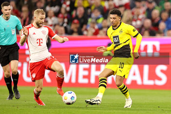 2024-03-30 - Konrad Laimer of Bayern Munich and Jadon Sancho of Borussia Dortmund during the German championship Bundesliga football match between Bayern Munich and Borussia Dortmund on March 30, 2024 at Allianz Arena in Munich, Germany - FOOTBALL - GERMAN CHAMP - BAYERN MUNICH V DORTMUND - GERMAN BUNDESLIGA - SOCCER