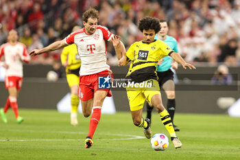 2024-03-30 - Leon Goretzka of Bayern Munich and Karim Adeyemi of Borussia Dortmund during the German championship Bundesliga football match between Bayern Munich and Borussia Dortmund on March 30, 2024 at Allianz Arena in Munich, Germany - FOOTBALL - GERMAN CHAMP - BAYERN MUNICH V DORTMUND - GERMAN BUNDESLIGA - SOCCER