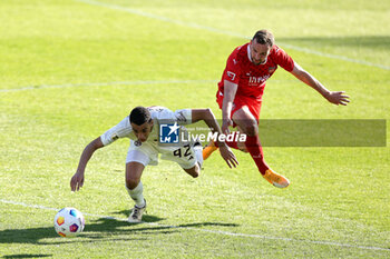 2024-04-06 - Jamal Musiala of Bayern Munich and Benedikt Gimber of Heidenheim during the German championship Bundesliga football match between FC Heidenheim and FC Bayern Munich on April 6, 2024 at Voith Arena in Heidenheim, Germany - FOOTBALL - GERMAN CHAMP - HEIDENHEIM V BAYERN MUNICH - GERMAN BUNDESLIGA - SOCCER