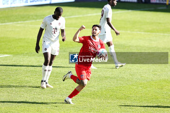 2024-04-06 - Kevin Sessa of Heidenheim celebrates his goal 1-2 during the German championship Bundesliga football match between FC Heidenheim and FC Bayern Munich on April 6, 2024 at Voith Arena in Heidenheim, Germany - FOOTBALL - GERMAN CHAMP - HEIDENHEIM V BAYERN MUNICH - GERMAN BUNDESLIGA - SOCCER