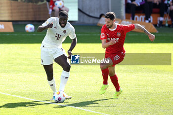 2024-04-06 - Dayot Upamecano of Bayern Munich and Tim Kleindienst of Heidenheim during the German championship Bundesliga football match between FC Heidenheim and FC Bayern Munich on April 6, 2024 at Voith Arena in Heidenheim, Germany - FOOTBALL - GERMAN CHAMP - HEIDENHEIM V BAYERN MUNICH - GERMAN BUNDESLIGA - SOCCER