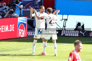 2024-04-06 - Harry Kane of Bayern Munich celebrates his goal 0-1 with Thomas Müller during the German championship Bundesliga football match between FC Heidenheim and FC Bayern Munich on April 6, 2024 at Voith Arena in Heidenheim, Germany - FOOTBALL - GERMAN CHAMP - HEIDENHEIM V BAYERN MUNICH - GERMAN BUNDESLIGA - SOCCER