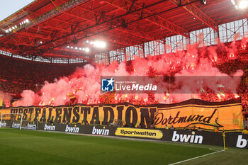 2024-04-06 - Fans of Borussia Dortmund, flares during the German championship Bundesliga football match between Borussia Dortmund and VfB Stuttgart on April 6, 2024 at Signal Iduna Park in Dortmund , Germany - FOOTBALL - GERMAN CHAMP - DORTMUND V STUTTGART - GERMAN BUNDESLIGA - SOCCER