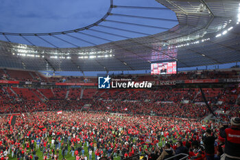 2024-04-14 - Leverkusen fans celebrate German league title 2024 following the German championship Bundesliga football match between Bayer Leverkusen and Werder Bremen on April 14, 2024 at BayArena in Leverkusen, Germany - FOOTBALL - GERMAN CHAMP - LEVERKUSEN V BREMEN - GERMAN BUNDESLIGA - SOCCER