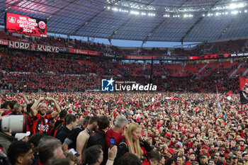 2024-04-14 - Leverkusen fans celebrate German league title 2024 following the German championship Bundesliga football match between Bayer Leverkusen and Werder Bremen on April 14, 2024 at BayArena in Leverkusen, Germany - FOOTBALL - GERMAN CHAMP - LEVERKUSEN V BREMEN - GERMAN BUNDESLIGA - SOCCER