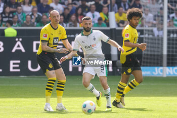 2024-04-13 - Franck Honorat of Borussia Mönchengladbach and Marius Wolf of Borussia Dortmund during the German championship Bundesliga football match between Borussia Mönchengladbach and Borussia Dortmund on April 13, 2024 at Borussia-Park in Mönchengladbach, Germany - FOOTBALL - GERMAN CHAMP - MONCHENGLADBACH V DORTMUND - GERMAN BUNDESLIGA - SOCCER