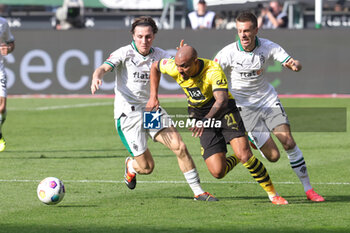 2024-04-13 - Donyell Malen of Borussia Dortmund and Rocco Reitz, Patrick Herrmann of Borussia Mönchengladbach during the German championship Bundesliga football match between Borussia Mönchengladbach and Borussia Dortmund on April 13, 2024 at Borussia-Park in Mönchengladbach, Germany - FOOTBALL - GERMAN CHAMP - MONCHENGLADBACH V DORTMUND - GERMAN BUNDESLIGA - SOCCER