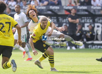 2024-04-13 - Ko Itakura of Borussia Mönchengladbach and Marcel Sabitzer of Borussia Dortmund during the German championship Bundesliga football match between Borussia Mönchengladbach and Borussia Dortmund on April 13, 2024 at Borussia-Park in Mönchengladbach, Germany - FOOTBALL - GERMAN CHAMP - MONCHENGLADBACH V DORTMUND - GERMAN BUNDESLIGA - SOCCER