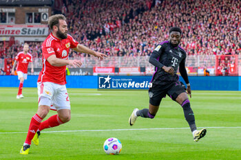 2024-04-20 - Lucas Tousart of Union Berlin and Alphonso Davies of Bayern Munich during the German championship Bundesliga football match between Union Berlin and Bayern Munich on April 20, 2024 at An der Alten Försterei stadium in Berlin, Germany - FOOTBALL - GERMAN CHAMP - UNION BERLIN V BAYERN MUNICH - GERMAN BUNDESLIGA - SOCCER