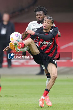 2024-05-05 - Edmond Tapsoba of Leverkusen and Hugo Ekitike of Frankfurt during the German championship Bundesliga football match between Eintracht Frankfurt and Bayer 04 Leverkusen on May 5, 2024 at Deutsche Bank Park in Frankfurt, Germany - FOOTBALL - GERMAN CHAMP - FRANKFURT V LEVERKUSEN - GERMAN BUNDESLIGA - SOCCER