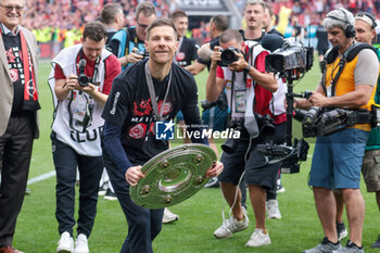 2024-05-18 - Bayer Leverkusen head coach Xabi Alonso celebrates the German championship title after the German championship Bundesliga football match between Bayer 04 Leverkusen and FC Augsburg on May 18, 2024 at BayArena in Leverkusen, Germany - FOOTBALL - GERMAN CHAMP - LEVERKUSEN V AUGSBURG - GERMAN BUNDESLIGA - SOCCER