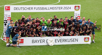 2024-05-18 - Bayer Leverkusen players celebrating the German championship title after the German championship Bundesliga football match between Bayer 04 Leverkusen and FC Augsburg on May 18, 2024 at BayArena in Leverkusen, Germany - FOOTBALL - GERMAN CHAMP - LEVERKUSEN V AUGSBURG - GERMAN BUNDESLIGA - SOCCER