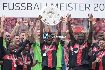 2024-05-18 - Bayer Leverkusen players with Edmond Tapsoba celebrating the German championship title after the German championship Bundesliga football match between Bayer 04 Leverkusen and FC Augsburg on May 18, 2024 at BayArena in Leverkusen, Germany - FOOTBALL - GERMAN CHAMP - LEVERKUSEN V AUGSBURG - GERMAN BUNDESLIGA - SOCCER