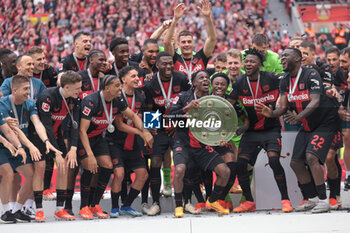 2024-05-18 - Bayer Leverkusen players with Jeremie Frimpong celebrating the German championship title after the German championship Bundesliga football match between Bayer 04 Leverkusen and FC Augsburg on May 18, 2024 at BayArena in Leverkusen, Germany - FOOTBALL - GERMAN CHAMP - LEVERKUSEN V AUGSBURG - GERMAN BUNDESLIGA - SOCCER