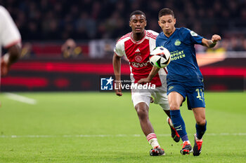 2024-02-03 - Jorrel Hato of Ajax battles for possession with Mauro Junior of PSV during the Netherlands championship Eredivisie football match between AFC Ajax and PSV on February 3, 2024 at Johan Cruijff ArenA in Amsterdam, Netherlands - FOOTBALL - NETHERLANDS CHAMP - AJAX V PSV - NETHERLANDS EREDIVISIE - SOCCER