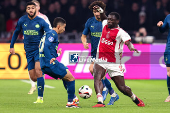 2024-02-03 - Brian Brobbey of Ajax battles for possession with Mauro Junior of PSV during the Netherlands championship Eredivisie football match between AFC Ajax and PSV on February 3, 2024 at Johan Cruijff ArenA in Amsterdam, Netherlands - FOOTBALL - NETHERLANDS CHAMP - AJAX V PSV - NETHERLANDS EREDIVISIE - SOCCER