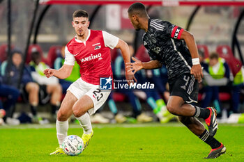 2024-02-25 - Mayckel Lahdo of AZ Alkmaar battles for possession with Jorrel Hato of AFC Ajax during the Netherlands championship Eredivisie football match between AZ and AFC Ajax on February 25, 2024 at AFAS Stadion in Alkmaar, Netherlands - FOOTBALL - NETHERLANDS CHAMP - AZ V AJAX - NETHERLANDS EREDIVISIE - SOCCER