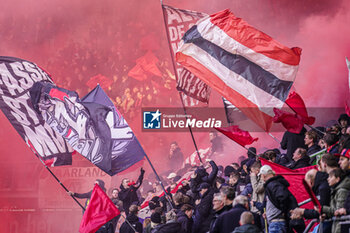 2024-02-25 - Fans and supporters of AZ Alkmaar waving flags using fireworks and creating lots of smoke during the Netherlands championship Eredivisie football match between AZ and AFC Ajax on February 25, 2024 at AFAS Stadion in Alkmaar, Netherlands - FOOTBALL - NETHERLANDS CHAMP - AZ V AJAX - NETHERLANDS EREDIVISIE - SOCCER