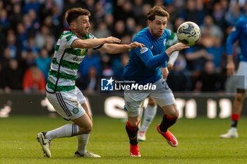 2024-04-07 - Greg Taylor of Celtic FC against Scott Wright of Rangers FC during the Scottish championship, Cinch Premiership football match between Rangers and Celtic on 7 April 2024 at Ibrox in Glasgow, Scotland - FOOTBALL - SCOTTISH CHAMP - RANGERS V CELTIC - SCOTTISH PREMIERSHIP - SOCCER