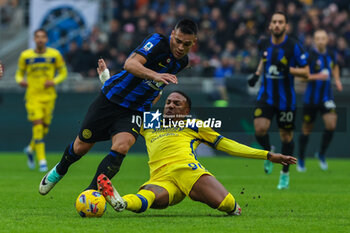 2024-01-06 - Lautaro Martinez of FC Internazionale competes for the ball with Michael Folorunsho of Hellas Verona FC during Serie A 2023/24 football match between FC Internazionale and Hellas Verona at Giuseppe Meazza Stadium, Milan, Italy on January 06, 2024 - INTER - FC INTERNAZIONALE VS HELLAS VERONA FC - ITALIAN SERIE A - SOCCER