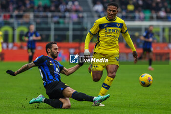 2024-01-06 - Hakan Calhanoglu of FC Internazionale seen in action with Michael Folorunsho of Hellas Verona FC during Serie A 2023/24 football match between FC Internazionale and Hellas Verona at Giuseppe Meazza Stadium, Milan, Italy on January 06, 2024 - INTER - FC INTERNAZIONALE VS HELLAS VERONA FC - ITALIAN SERIE A - SOCCER
