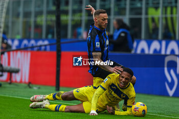 2024-01-06 - Marko Arnautovic of FC Internazionale competes for the ball with Michael Folorunsho of Hellas Verona FC during Serie A 2023/24 football match between FC Internazionale and Hellas Verona at Giuseppe Meazza Stadium, Milan, Italy on January 06, 2024 - INTER - FC INTERNAZIONALE VS HELLAS VERONA FC - ITALIAN SERIE A - SOCCER