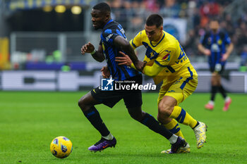 2024-01-06 - Marcus Thuram of FC Internazionale competes for the ball with Diego Coppola of Hellas Verona FC during Serie A 2023/24 football match between FC Internazionale and Hellas Verona at Giuseppe Meazza Stadium, Milan, Italy on January 06, 2024 - INTER - FC INTERNAZIONALE VS HELLAS VERONA FC - ITALIAN SERIE A - SOCCER