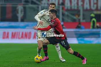 2024-01-14 - Christian Pulisic of AC Milan competes for the ball with \Diego LLorente of AS Roma during Serie A 2023/24 football match between AC Milan and AS Roma at San Siro Stadium, Milan, Italy on January 14, 2024 - AC MILAN VS AS ROMA - ITALIAN SERIE A - SOCCER