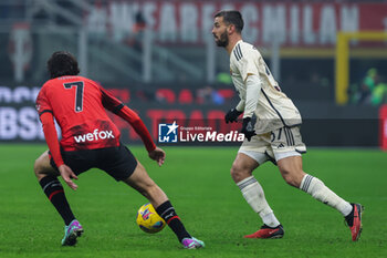 2024-01-14 - Leonardo Spinazzola of AS Roma competes for the ball with Yacine Adli of AC Milan during Serie A 2023/24 football match between AC Milan and AS Roma at San Siro Stadium, Milan, Italy on January 14, 2024 - AC MILAN VS AS ROMA - ITALIAN SERIE A - SOCCER